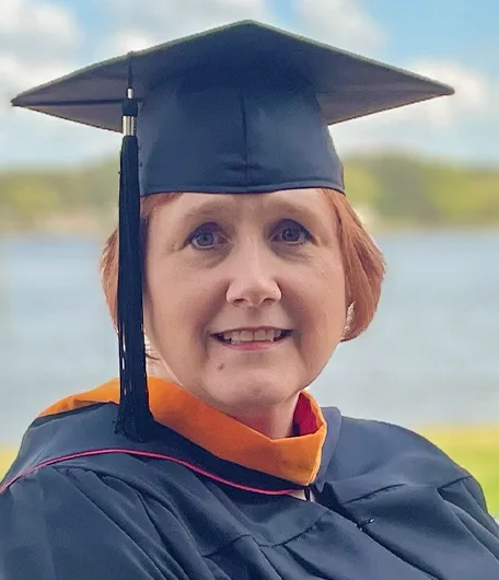 Kathryn Funk at graduation in her cap and gown
